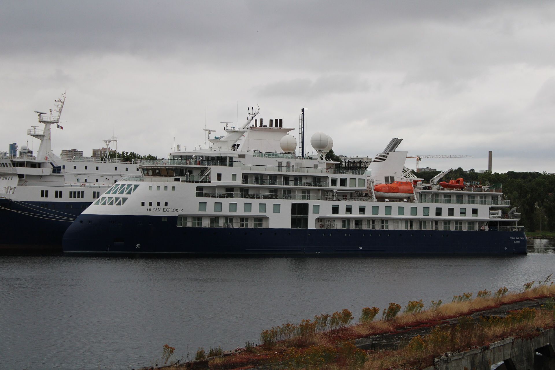 Ocean Explorer, navy hull and white superstructure with an inverted X-Bow, moored at Hérouville-Saint-Clair, France, July 2024