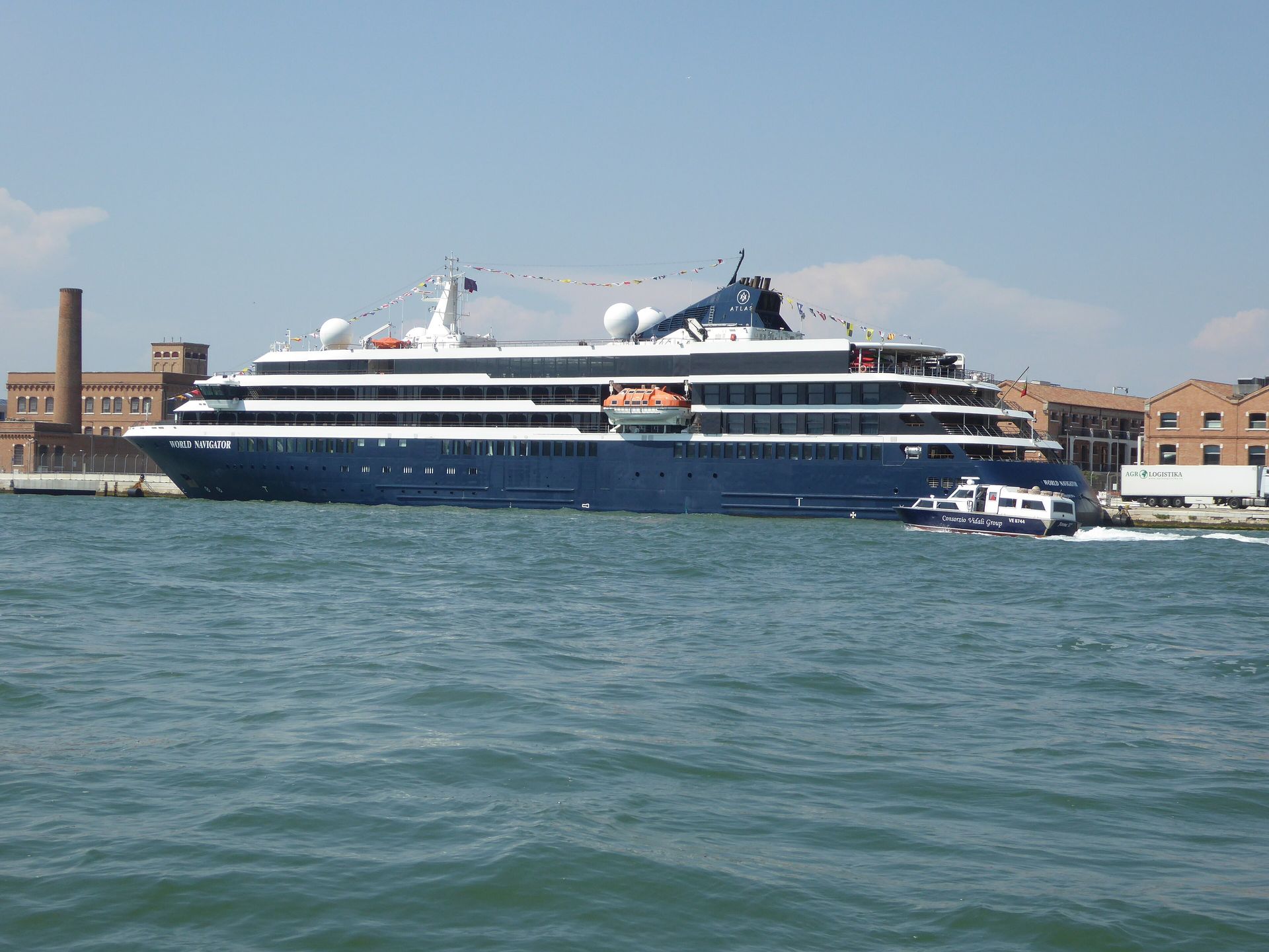 Atlas Ocean Voyages' World Navigator in Venice in August 2023, with the Atlas logo on its funnel