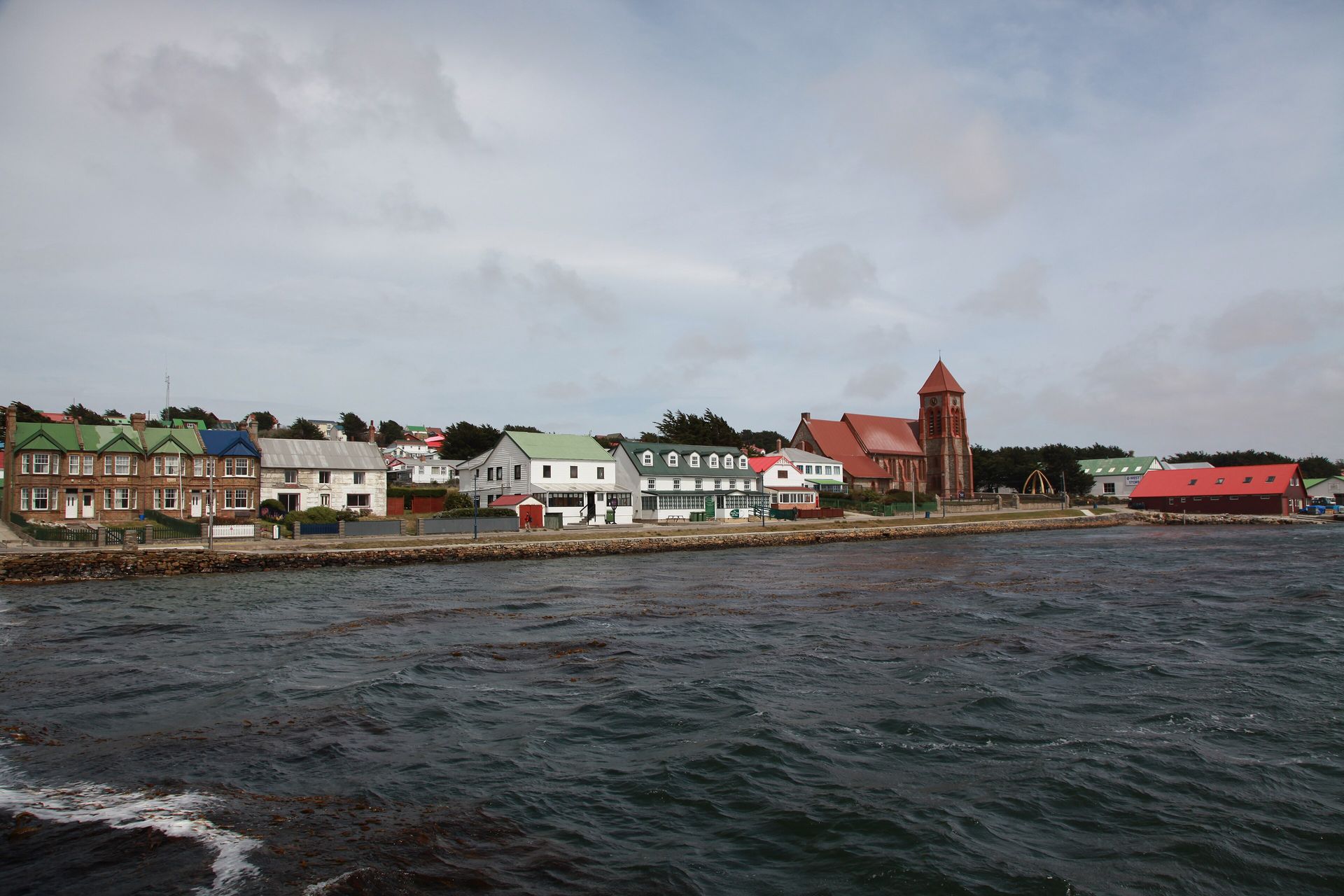 Stanley waterfront with the Jubilee Villas on the left and Christ Church Cathedral and the Whalebone Arch on the right