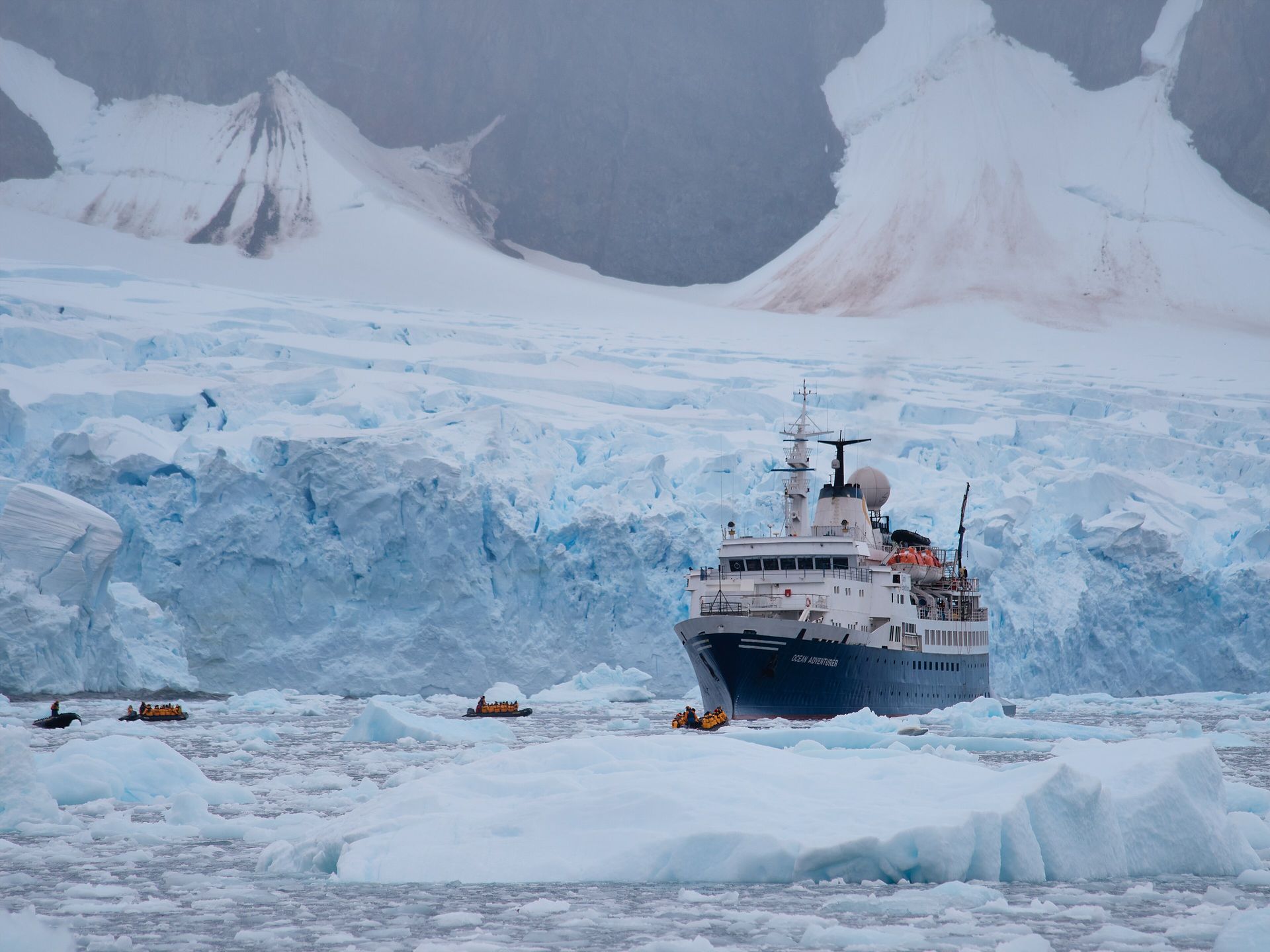 The ship now sailing as G Adventures' Expedition, then named Ocean Adventurer, in brash ice off Antarctica in 2023