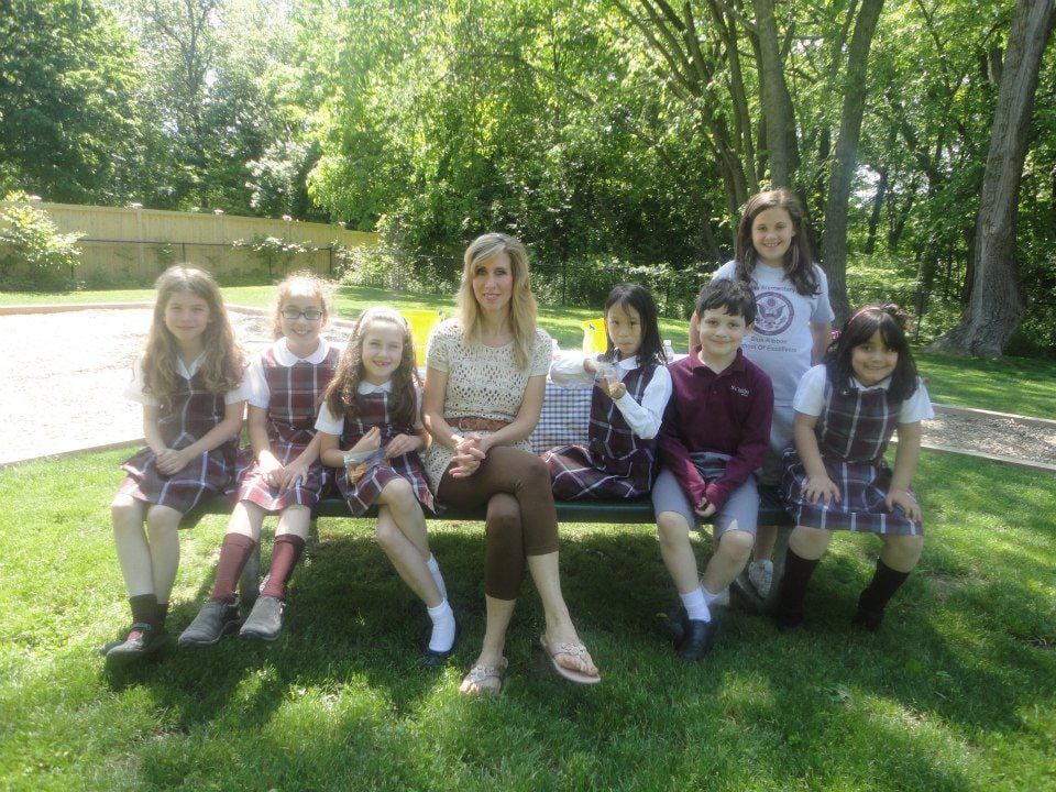 Cathy McCarthy outdoors with a group of her early students