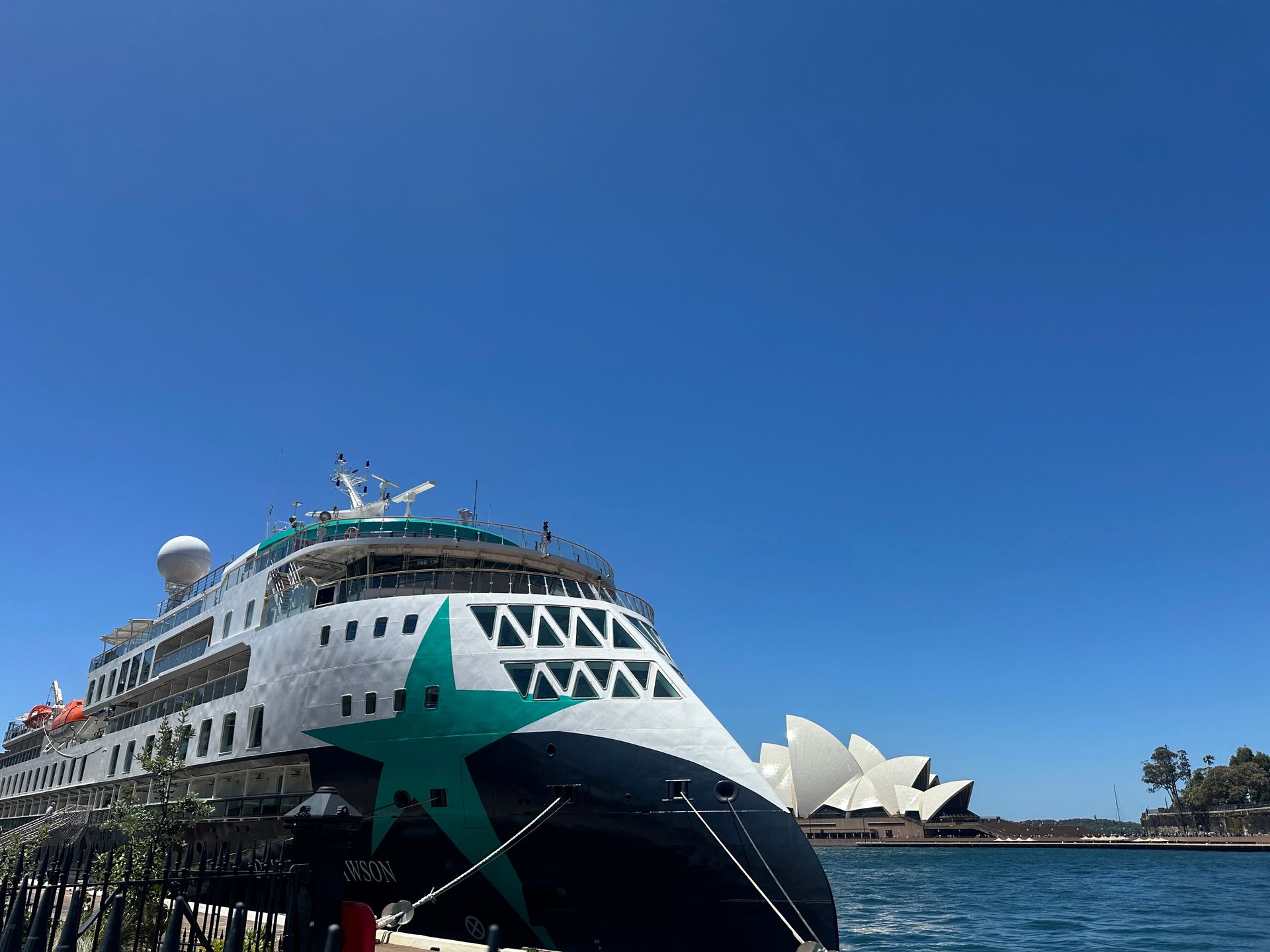 Bow of Aurora Expeditions' Douglas Mawson, docked in Sydney Harbour beside the Sydney Opera House in November 2025