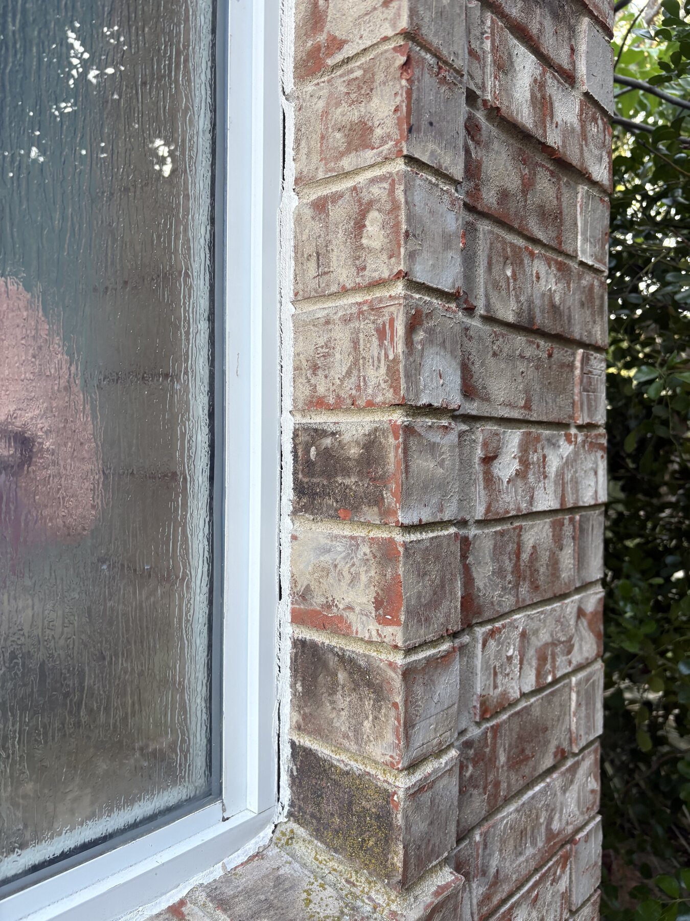Before photo of a Round Rock brick window corner
