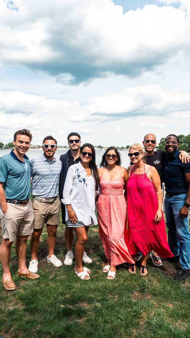 The team gathered together on the waterfront on a summer day