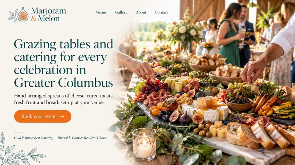 Catering website design, grazing tables with an abundant outdoor spread: cream page, a deep green serif headline, an orange book button and an abundant grazing table of cheese, fruit and bread at an outdoor party