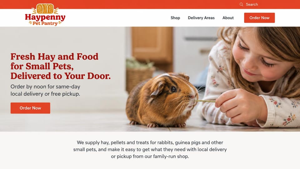 Pet business website design, small pet supply shop with local delivery: red top bar, a deep red serif headline beside a child feeding hay to a guinea pig, a red order button