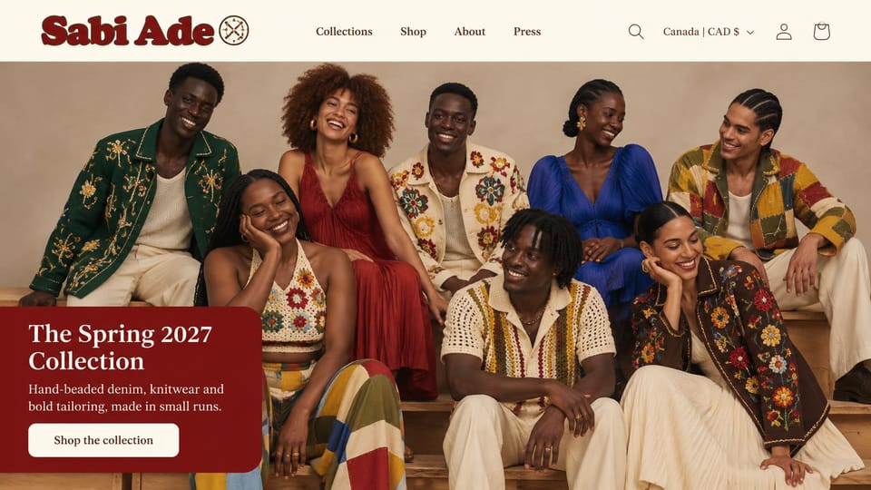 Fashion website design, embroidered and beaded jackets on a group of models: cream header with a heavy dark red logo, eight laughing models in embroidered, beaded, crochet and patchwork pieces, a dark red rounded panel with a serif headline and a cream button