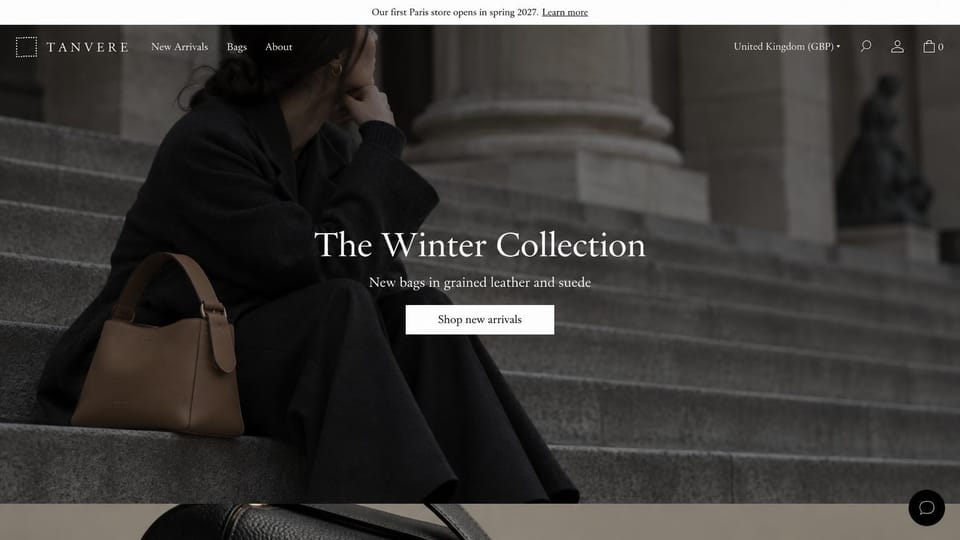 Fashion website design, leather bags on stone steps: dark photo of a woman in black on stone steps with a tan leather bag, centered white serif headline and a white button