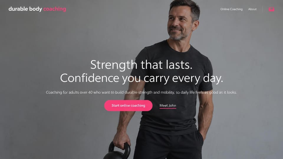 Personal trainer website design, online coaching for over 40s on a plain gray backdrop: muted gray studio photo of a smiling middle-aged man holding a kettlebell, a centered white headline, a pink button and a text link
