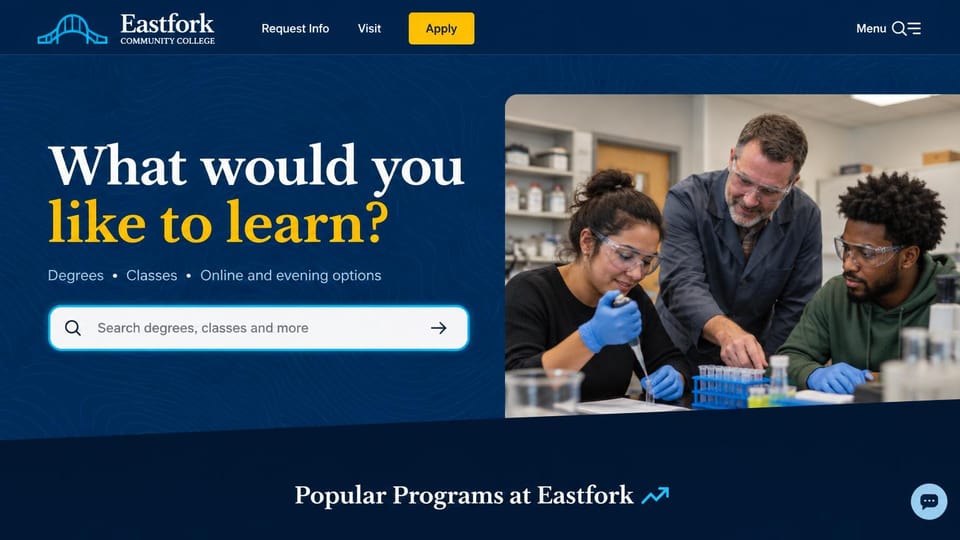 School website design, community college with a program search box: navy page, a white and gold serif headline, a large search field, a lab photo of two students and an instructor, and a yellow apply button