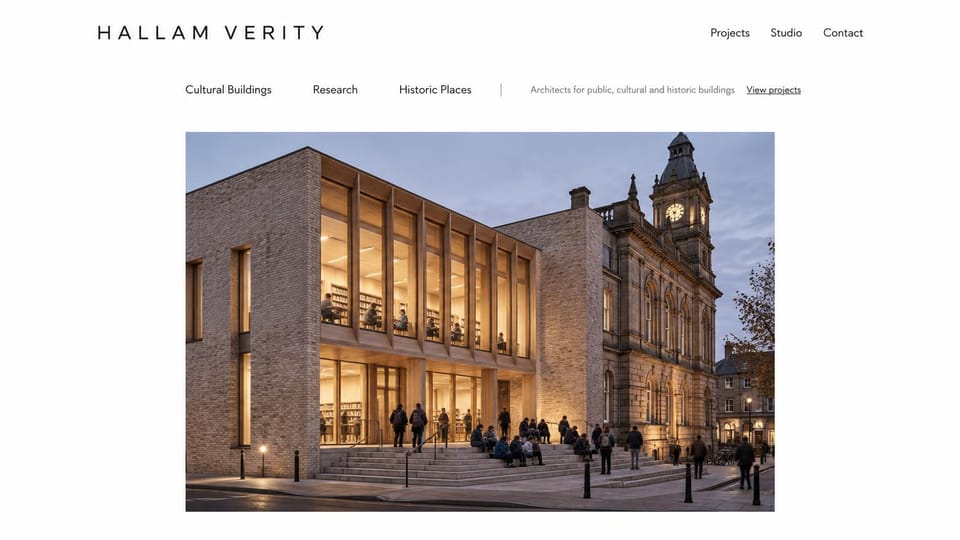 Portfolio website design, architects for cultural and historic buildings: white page, spaced navy name, sector links and a dusk photo of a modern library beside a clock tower