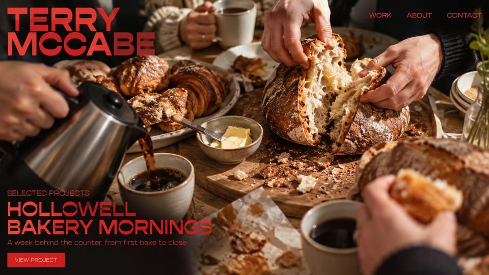 Photography website design, food and restaurant work, bold and red: a full-screen bakery table with coffee and bread, a bold red name and project title, a red view project button