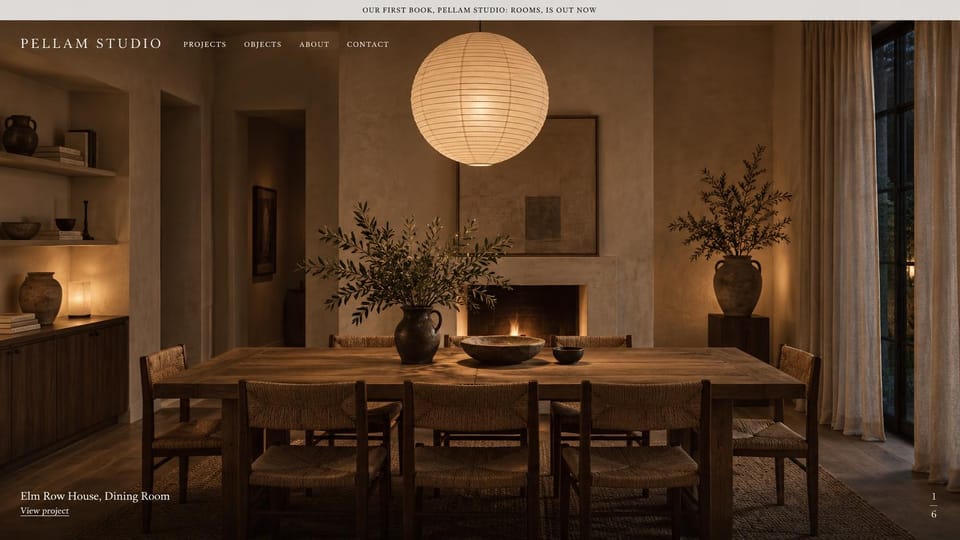 Interior design website design, evening rooms with a news bar on top: a dark dining room lit by a paper lantern, a pale announcement bar above a white serif menu
