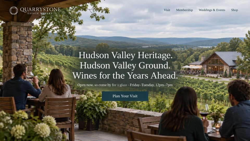 Winery and brewery website design, winery terrace under a stone porch, with open days: photo from a stone porch of couples at terrace tables over vineyard hills and a timber tasting barn, a three-line white serif headline and a navy visit button
