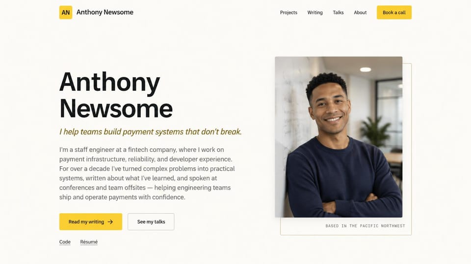Resume website design, staff engineer leading with writing and talks: warm white page, a large black name, an olive italic line, a yellow writing button, an outlined talks button and a smiling man in a navy sweater in an offset frame
