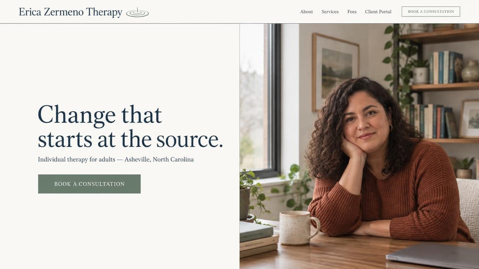 Business website design, individual therapy for adults, simple and direct: off-white page, a navy serif headline and a sage button beside a smiling woman in a rust sweater at a desk with a mug