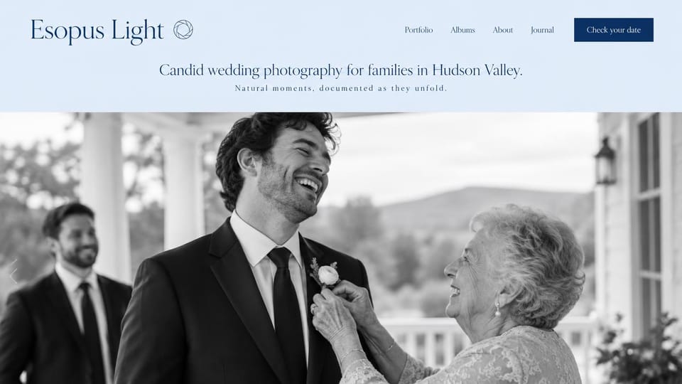 Wedding photographer website design, family-focused wedding photographer in pale blue and black and white: pale blue header band with a navy serif logo and a navy button, a centered navy tagline, a large black-and-white photo of a grandmother pinning a laughing groom's flower