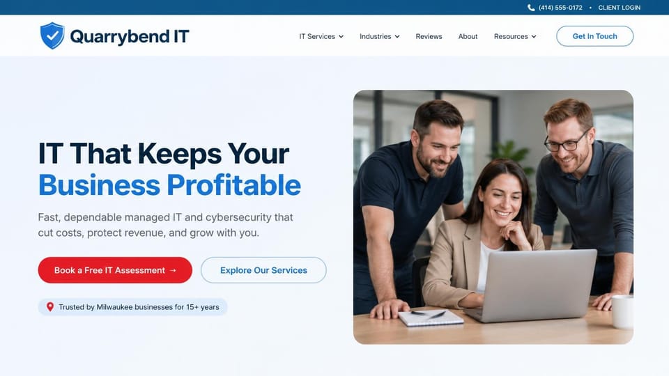 IT company website design, managed IT with a team around one laptop: pale blue-white page, navy and blue headline, red assessment button and outlined services button, three colleagues smiling at a laptop in a rounded photo