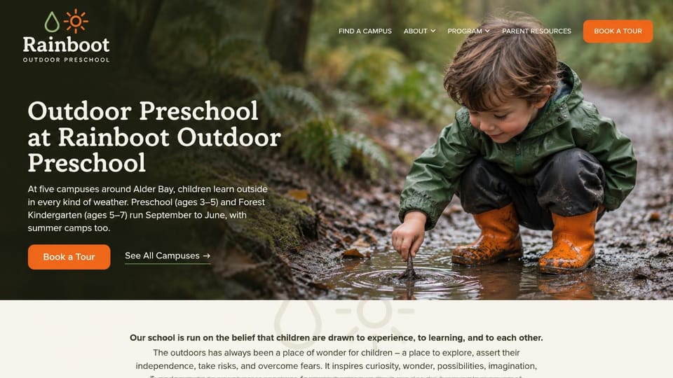 Daycare website design, outdoor preschool with a child in a muddy puddle: dark forest photo of a child in a green raincoat and orange boots poking a puddle with a stick, a cream serif headline and an orange tour button
