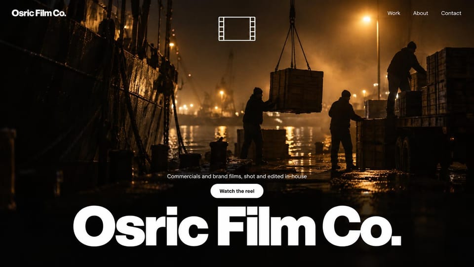 Videographer website design, commercials with the studio name set huge: dark night harbor with dock workers loading crates under amber lights, a film-frame icon, a white reel button and an oversized bold white name along the bottom