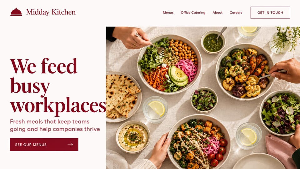 Catering website design, office catering with shared bowls from above: warm white page, oversized burgundy serif headline, a burgundy menus button, an overhead photo of grain bowls, flatbread, hummus and salads with hands reaching in