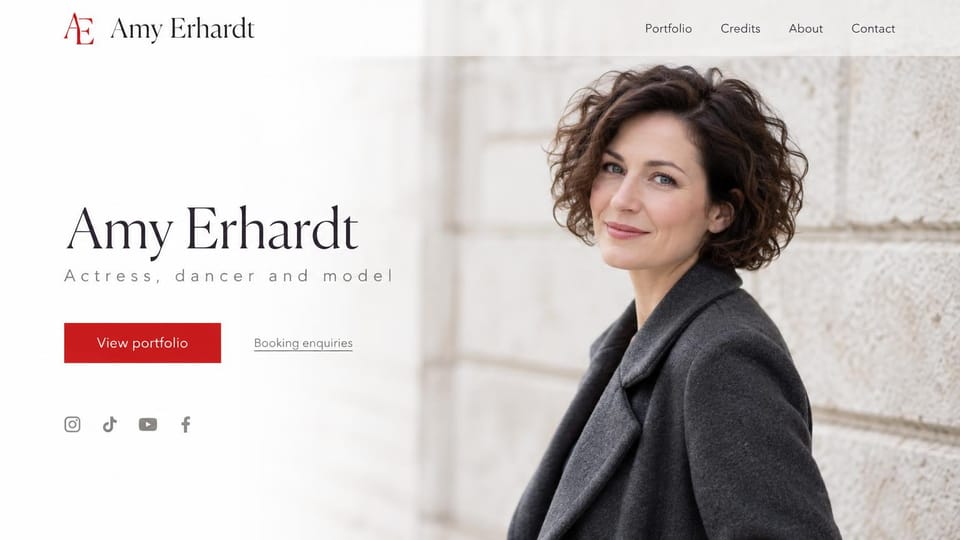 Model portfolio website design, actress, dancer and model with a credits page: pale stone wall, a smiling woman with short dark curls in a charcoal coat, a dark serif name, spaced gray type, a red portfolio button and small social icons