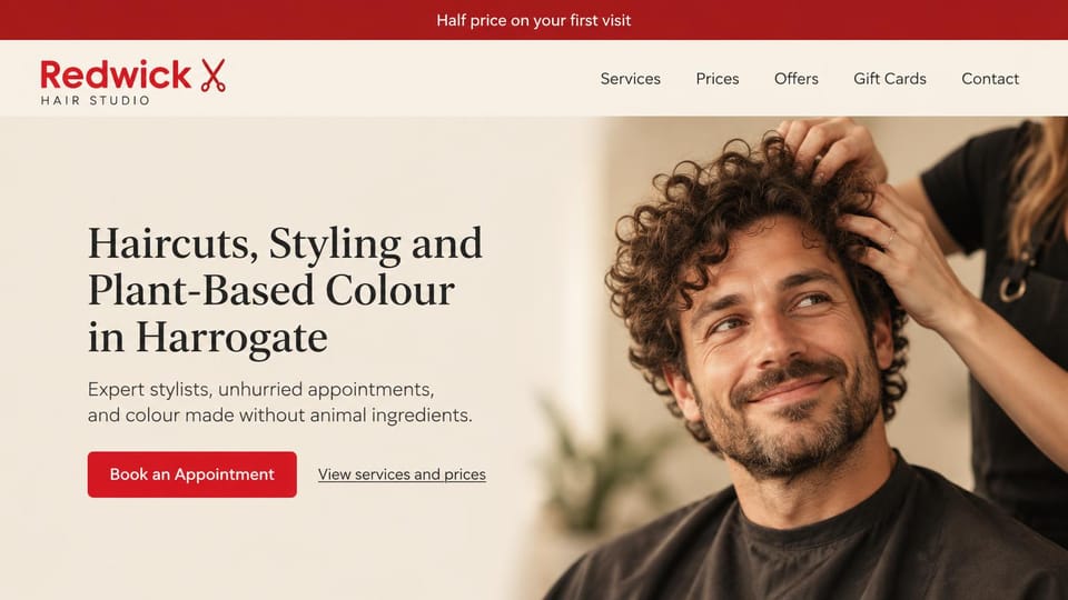 Salon website design, plant-based color with a warm portrait: cream and red, a curly-haired man having his hair styled, dark serif headline and red button