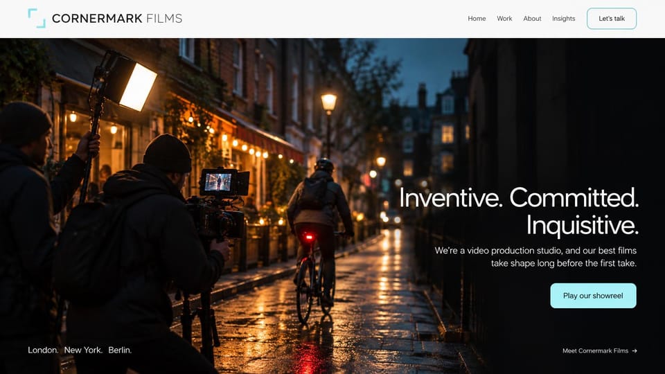 Videographer website design, production studio with a night street shoot: white header, a crew filming a cyclist on a wet night street, right-aligned white headline and a cyan showreel button
