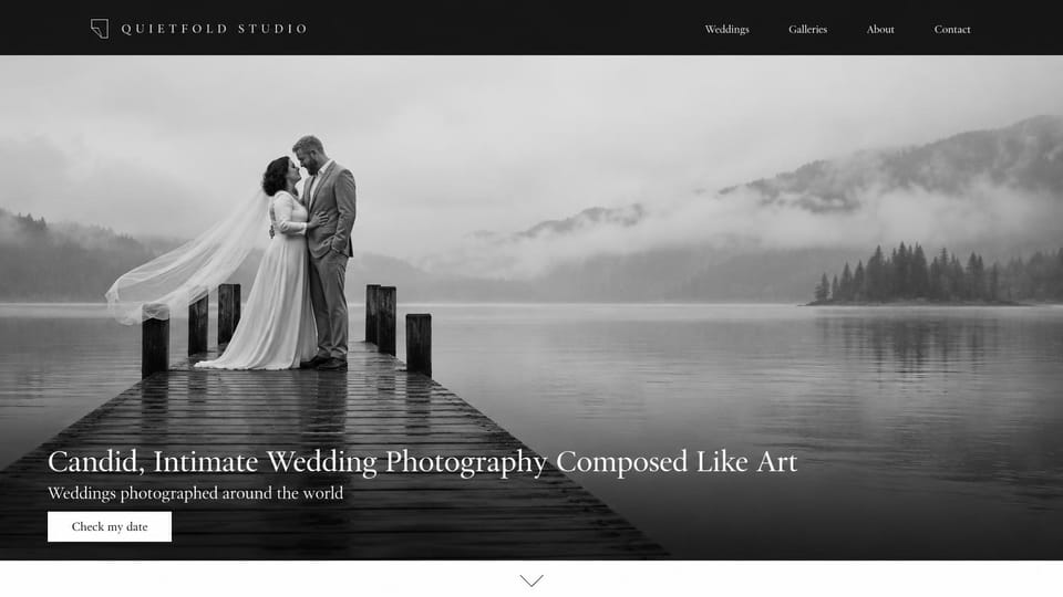 Wedding photographer website design, fine art wedding photography in black and white: black menu bar, a black-and-white photo of a couple kissing on a lake dock with a long veil in the mist, a white serif headline along the bottom and a white button