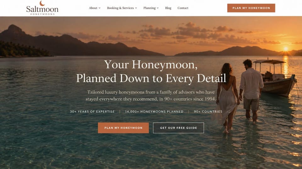 Travel agency website design, honeymoon planner with a couple at sunset: white header with a terracotta button, sunset photo of a couple wading toward a wooden boat by an island, centered white serif headline, a line of stats and terracotta and outlined buttons
