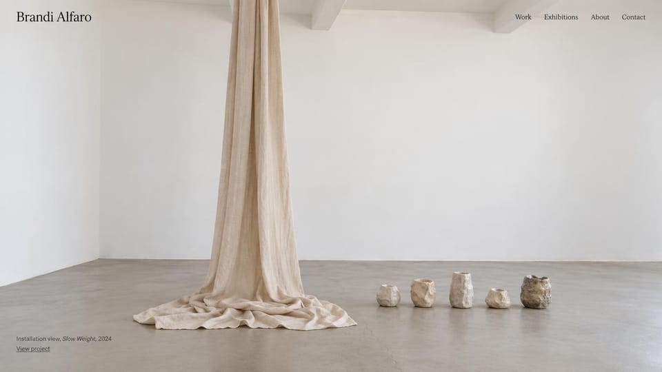 Artist website design, installation in a white gallery: a white gallery with a draped linen sculpture and small ceramic forms on a concrete floor, a small name at top left