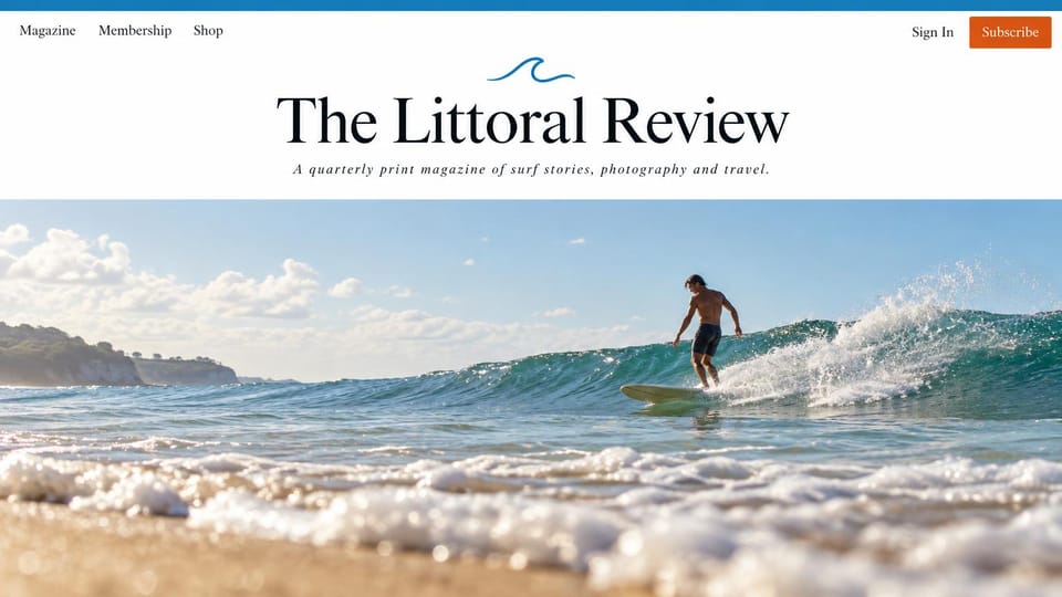 News and magazine website design, surf and travel quarterly with a centered masthead: white header with a blue wave mark, large black serif masthead and italic tagline, orange subscribe button, a surfer riding a green wave seen from the shoreline