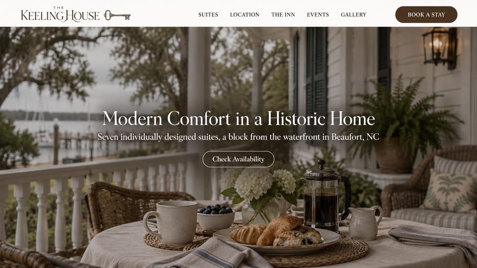 Bed and breakfast website design, historic home by the waterfront: a porch breakfast of croissants and coffee under oaks with a harbor behind, centered white serif headline, brown button