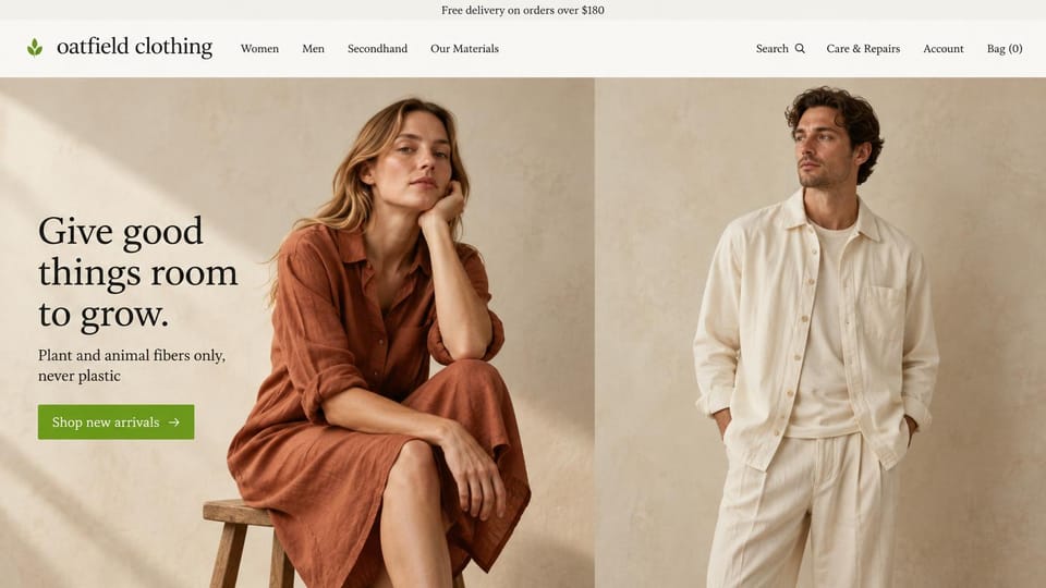 Business website design, natural-fiber clothing in a two-photo split: cream page, a dark serif headline and green button beside a woman in a rust linen dress on a stool and a man in a cream linen overshirt