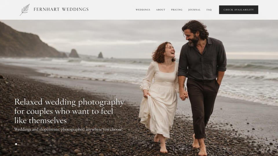 Wedding photographer website design, relaxed elopement photographer on a pebble beach: light grey menu with a leaf logo and a black button, a barefoot couple walking hand in hand on a pebble beach, a white serif headline lower left