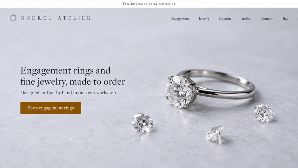 Jewelry website design, engagement rings with a solitaire on pale stone: pale gray stone background, a platinum solitaire ring with three loose diamonds, spaced dark wordmark with a gem outline, dark serif headline, amber shop button