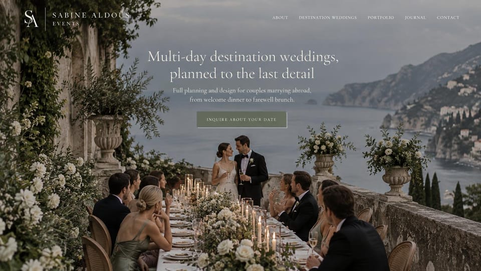 Wedding planner website design, multi-day destination weddings on a cliffside terrace: blue-gray photo of a cliffside terrace dinner above the sea, centered white serif headline, sage inquiry button