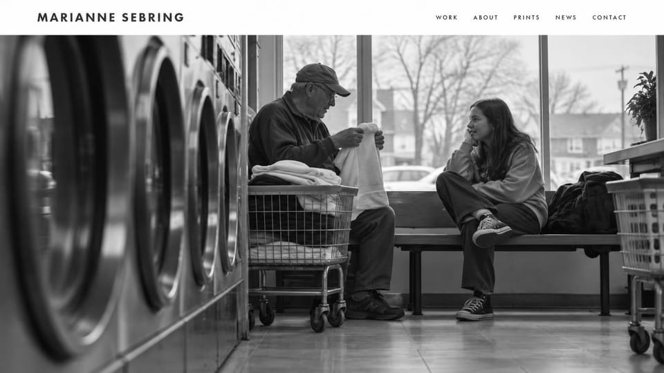 Photography website design, documentary in black and white with prints: white header above a large black and white photo of two people talking in a laundromat