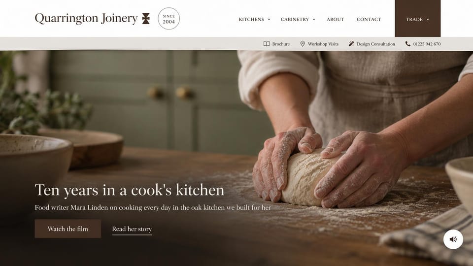 Carpentry website design, kitchen maker that leads with a client's story: white header with a dark trade tab, a pale utility bar, hands kneading dough on an oak counter, a white serif headline and a dark brown button
