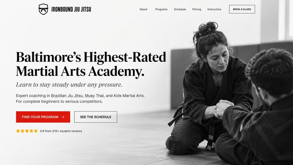 Martial arts website design, jiu-jitsu academy in black and white: white page, a large black serif headline, a red button and an outlined button, a black-and-white photo of two jiu-jitsu students on the mat