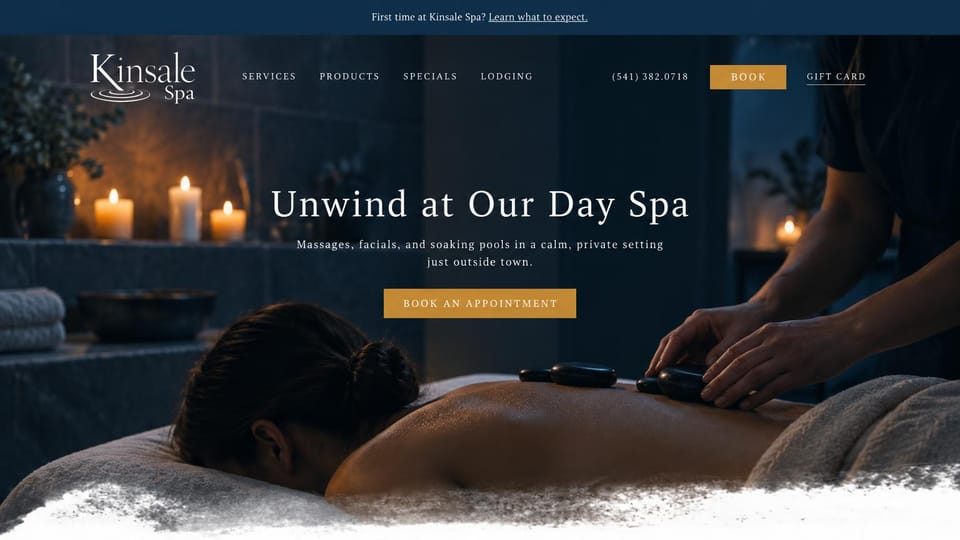 Salon website design, day spa with a candlelit massage: deep navy and gold, a hot stone massage by candlelight under a centered white headline
