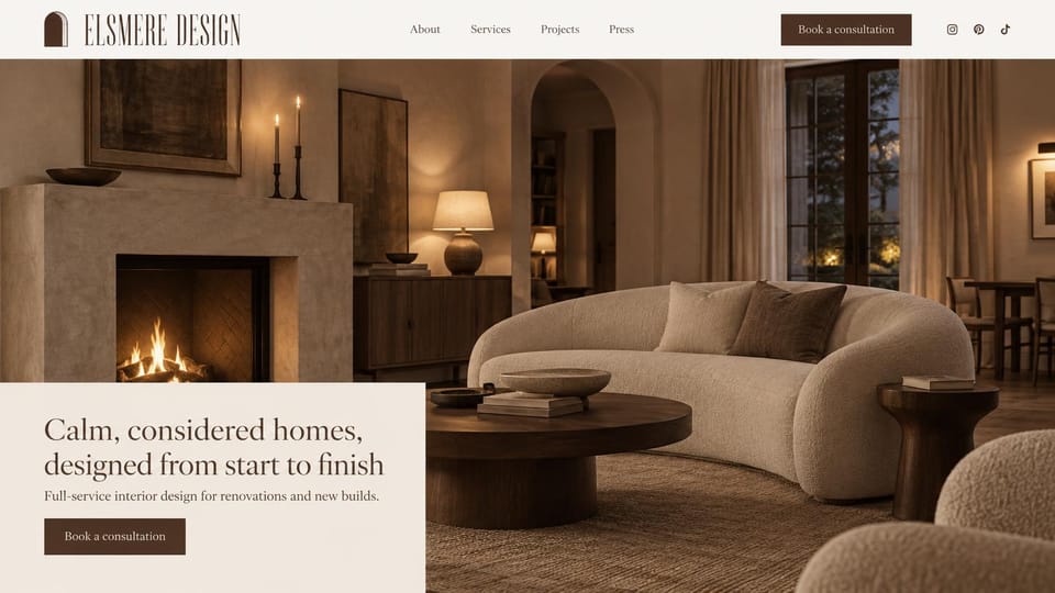 Interior design website design, renovations and new builds by firelight: a firelit living room with a curved boucle sofa in brown and beige, a cream panel with a dark serif headline and a brown button
