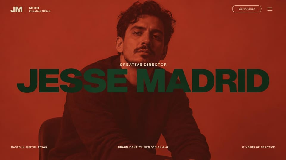 Portfolio website design, creative director in red: red-orange tinted portrait of a seated man, an oversized dark green name across the center and small details below