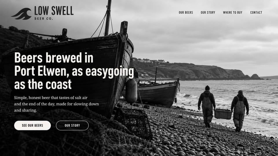 Winery and brewery website design, coastal brewery in black and white: black and white photo of two fishermen carrying a crate along a stony beach by a boat, a condensed white headline and white pill buttons