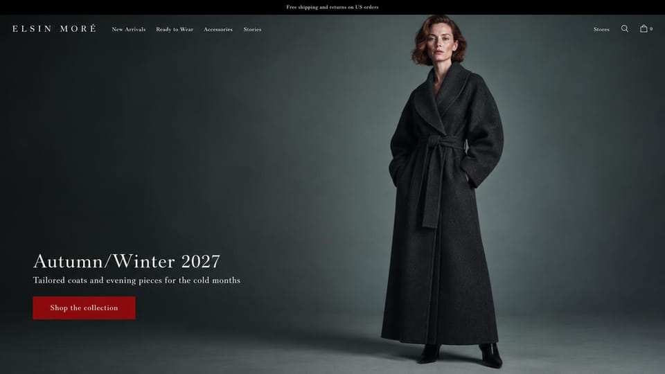 Fashion website design, luxury coats on a dark slate backdrop: dark slate studio, a red-haired woman in a floor-length charcoal wrap coat, a spaced serif logo, a white serif headline and a deep red button
