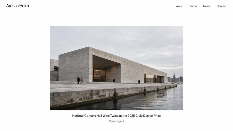 Portfolio website design, architecture studio, one building at a time: white page, a centered photo of a long concrete concert hall on a waterfront, a one-line caption below