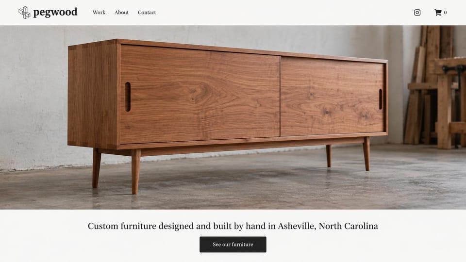 Carpentry website design, custom furniture with one piece full width: white header, a full-width walnut sideboard on a concrete floor in a workshop, a centered serif line and a black button