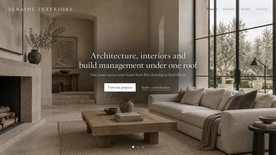 Interior design website design, architecture and interiors under one roof: a stone-toned living room with tall steel windows, a centered white serif headline and two buttons