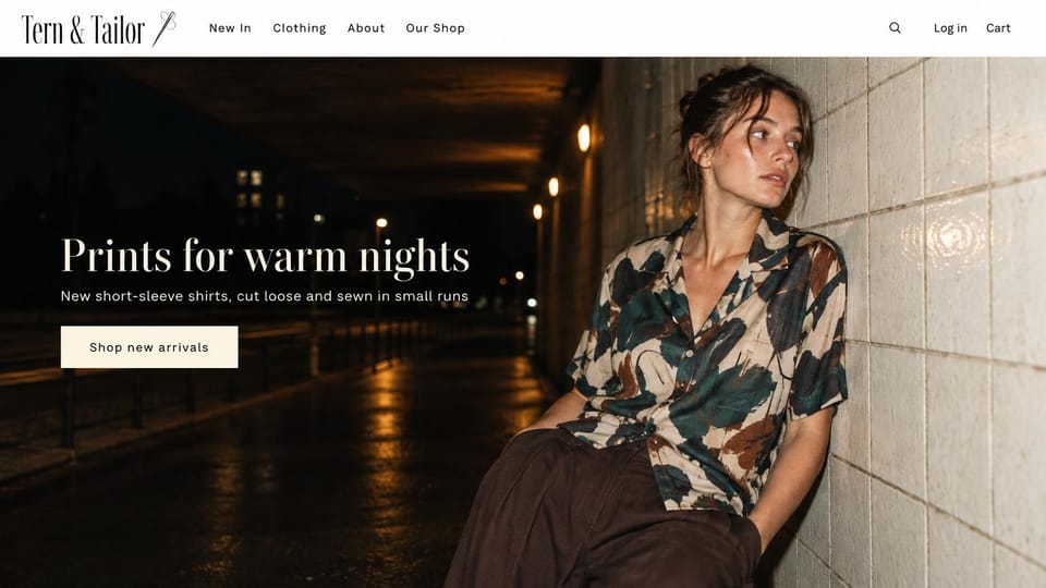 Fashion website design, printed shirts in a lamp-lit underpass at night: white header with a needle logo, a night underpass with amber lamps and a woman in a leaf-print camp shirt leaning on white tiles, a white serif headline and a cream button