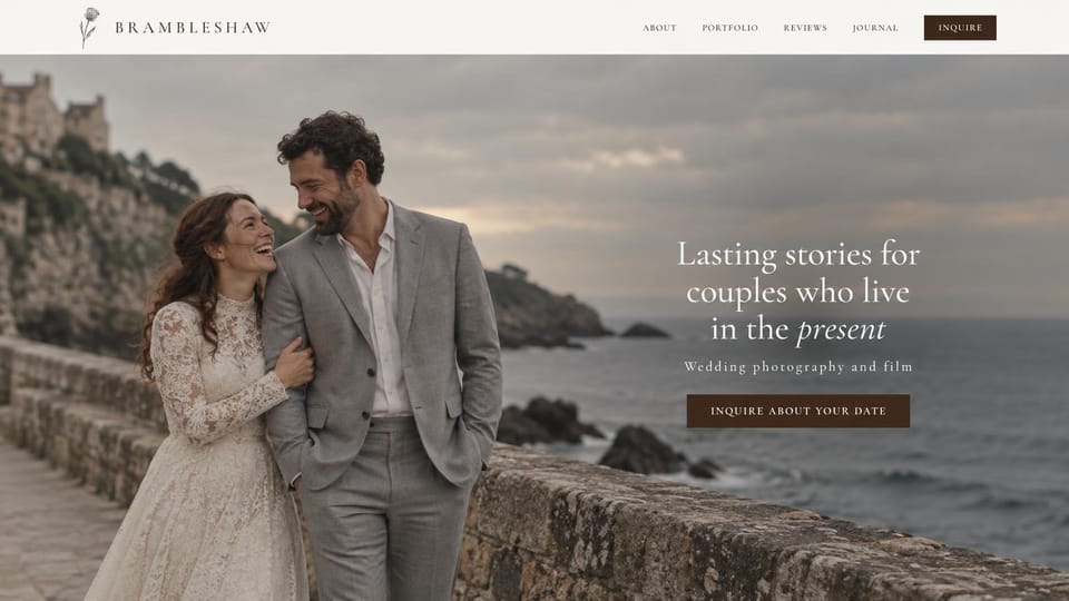 Wedding photographer website design, photo and film studio with a seaside wall portrait: cream menu, a laughing couple at a stone sea wall under an overcast sky, a white serif headline with an italic word and a dark brown button